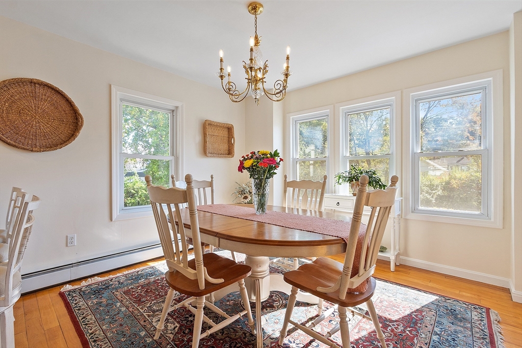44 Hamlin Street Lunenburg, MA 01462 - Photo 16 of 35 a view of a dining room with furniture a chandelier and wooden floor