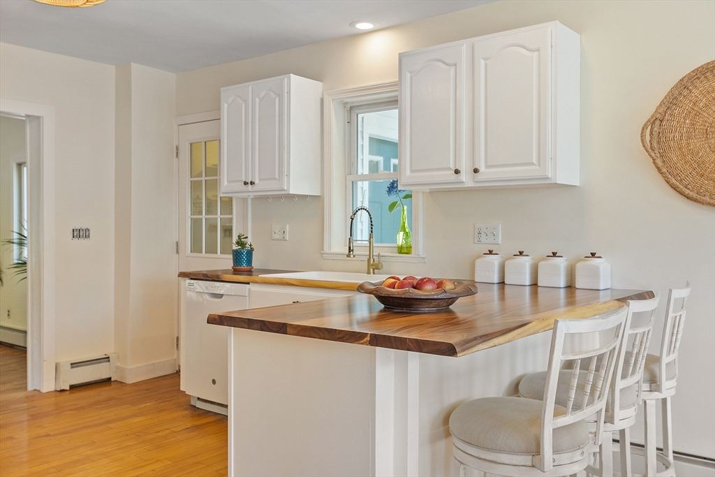 44 Hamlin Street Lunenburg, MA 01462 - Photo 18 of 35 a kitchen with stainless steel appliances granite countertop a sink a stove a dining table and chairs
