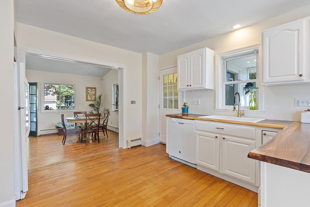 44 Hamlin Street Lunenburg, MA 01462 - Photo 19 of 35 a kitchen with cabinets and wooden floor