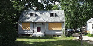 1212 Samuelson Road Rockford, IL 61109 - Photo 1 of 1 a view of a house with brick walls and a yard with a large tree