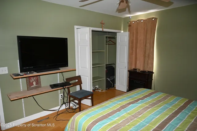 a bedroom with a bed and a flat screen tv