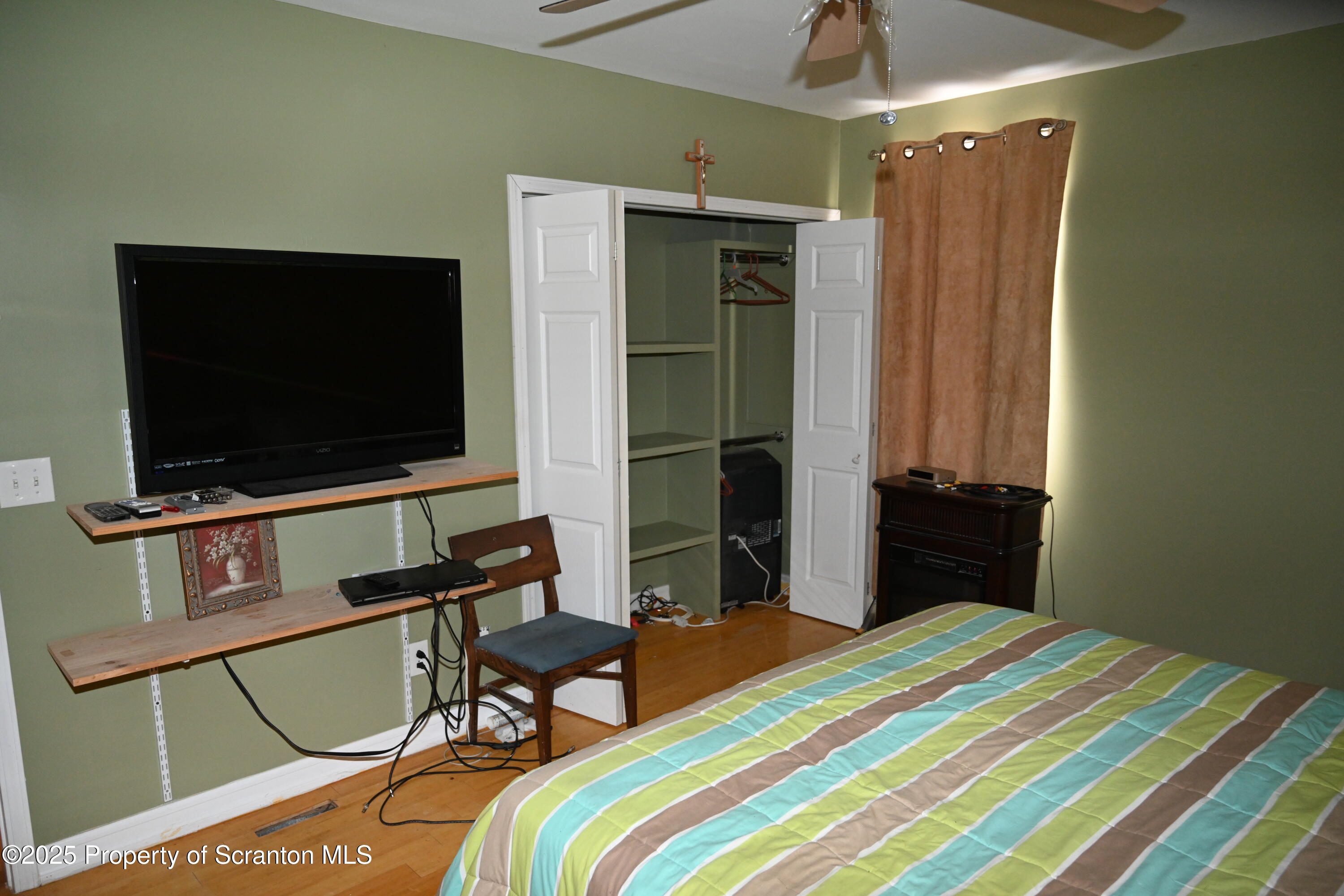 93 Prospect Street Hallstead, PA 18822 - Photo 15 of 32 a bedroom with a bed and a flat screen tv