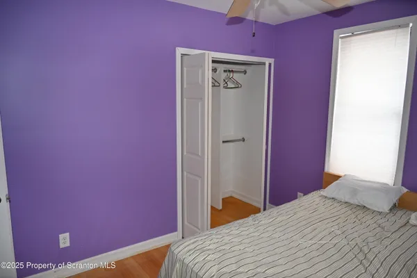 a bedroom with a bed and a mirror