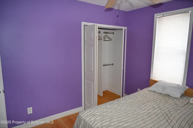 a bedroom with a bed and a mirror