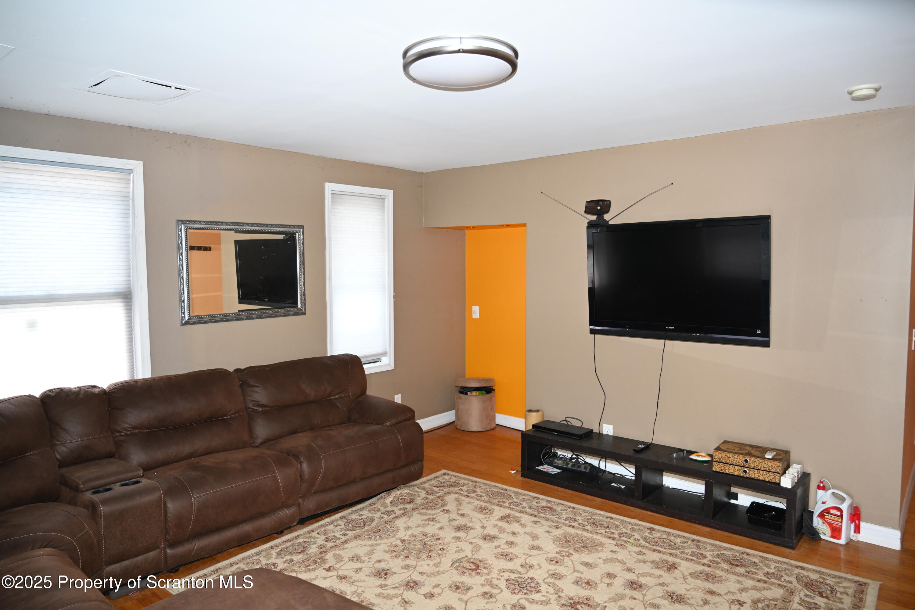 93 Prospect Street Hallstead, PA 18822 - Photo 2 of 32 a living room with furniture and a flat screen tv