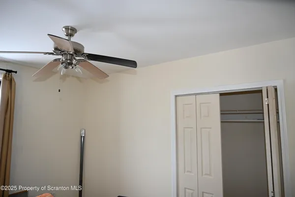 a view of a room with a ceiling fan