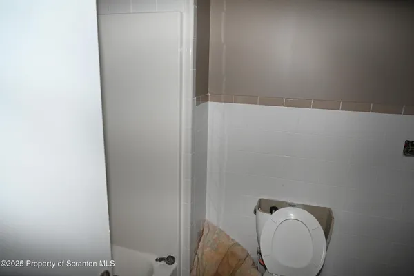 a bathroom with a toilet and a sink