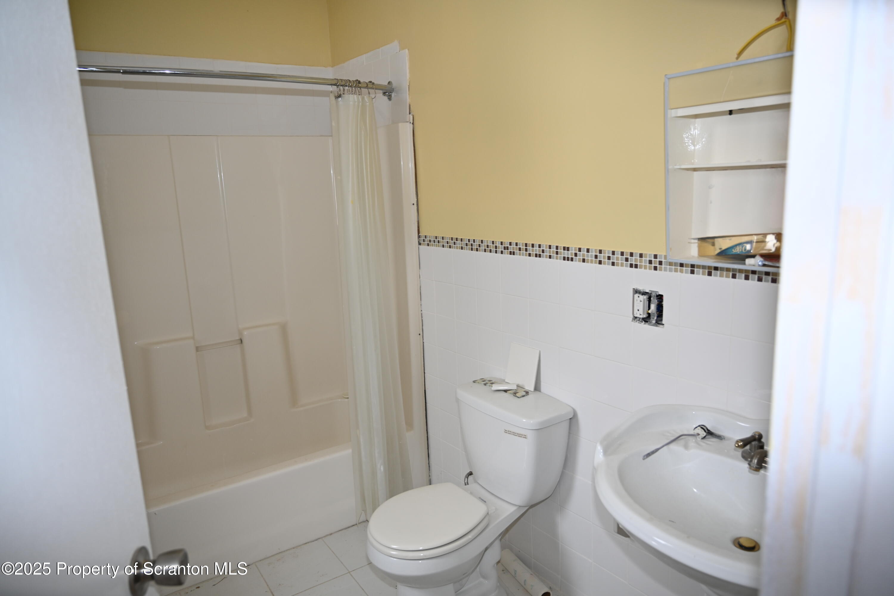 93 Prospect Street Hallstead, PA 18822 - Photo 27 of 32 a bathroom with a sink a toilet and shower