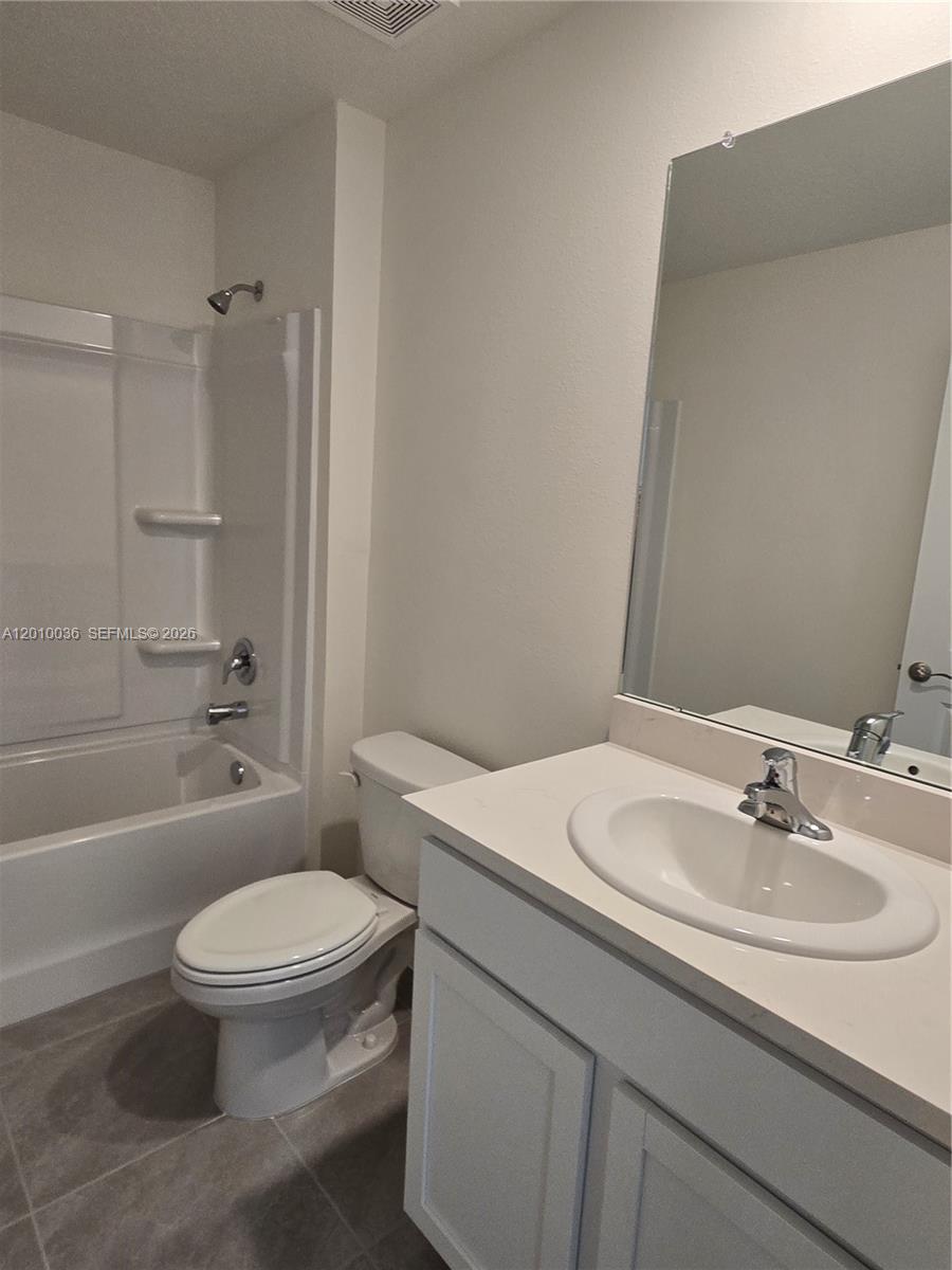 9871 Southeast 161st Lane Road Summerfield, FL 34491 - Photo 15 of 31 a bathroom with a sink toilet and shower