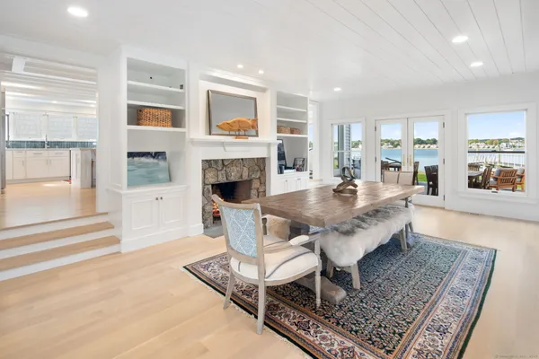 a living room with fireplace furniture and a rug