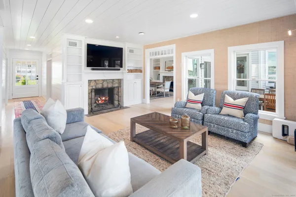 a living room with furniture a fireplace and a flat screen tv