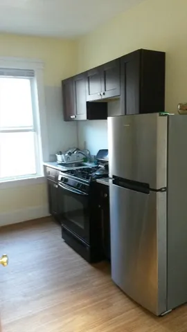 a kitchen with a refrigerator and a stove