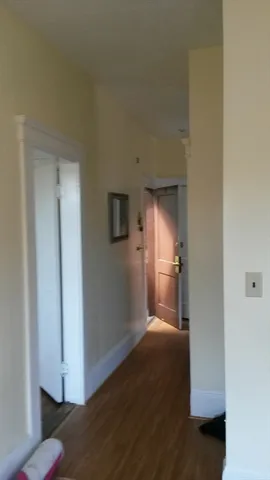 a view of a room with wooden floor and cabinet