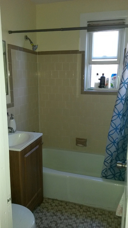 114 Shurtleff Street, Unit 9 Chelsea, MA 02150 - Photo 5 of 5 a bathroom with a sink a toilet a window and bathtub