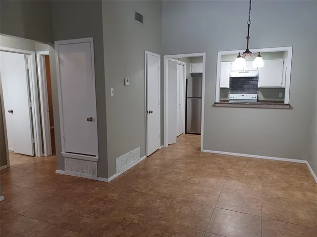a view of a kitchen with a refrigerator and a sink