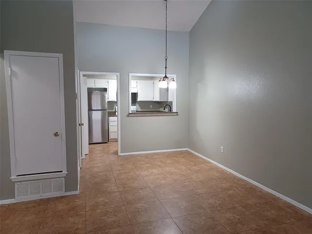 a view of a kitchen with a refrigerator a microwave and a stove top oven