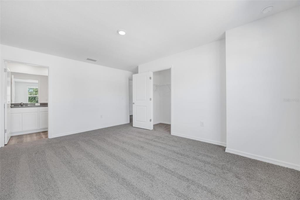 1009 Spotted Egret Loop Ruskin, FL 33570 - Photo 18 of 33 a view of an empty room with wooden floor and kitchen space