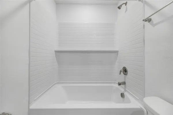 a bedroom with a bed and a potted plant