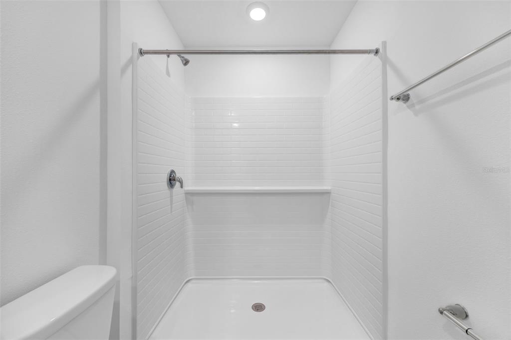 1009 Spotted Egret Loop Ruskin, FL 33570 - Photo 25 of 33 a bathroom with a shower and a toilet