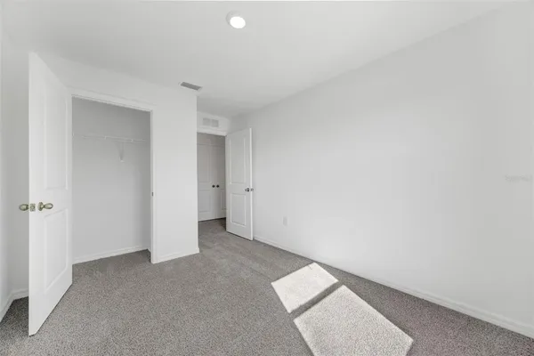 a bedroom with a bed and a potted plant