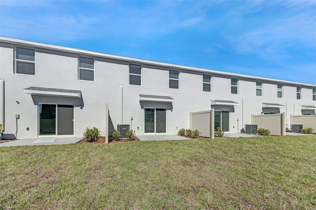1009 Spotted Egret Loop Ruskin, FL 33570 - Photo 32 of 33 a front view of a house with a yard