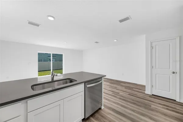 a view of kitchen and wooden floor