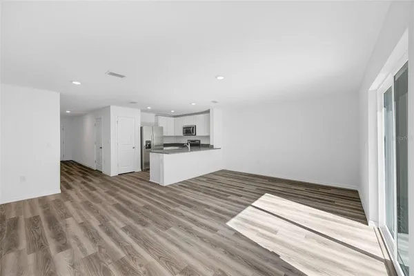 a view of kitchen with microwave and cabinets