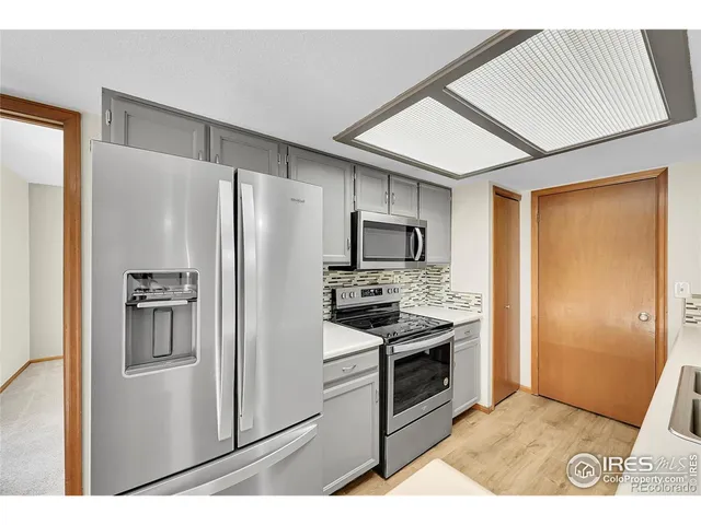 a kitchen with stainless steel appliances a refrigerator sink and stove