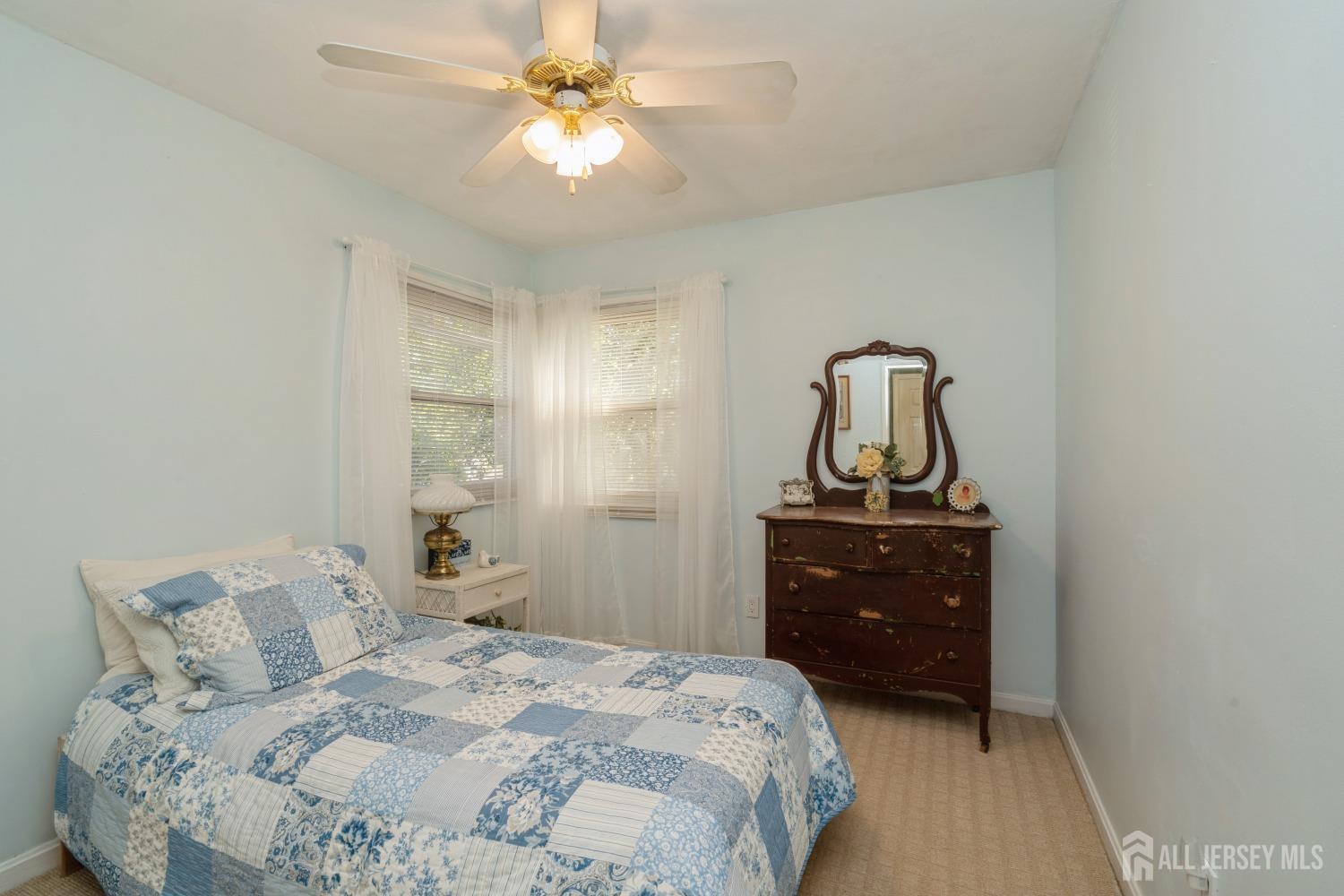 22 Constable Road Kendall Park, NJ 08824 - Photo 12 of 32 a bedroom with a bed and a chandelier