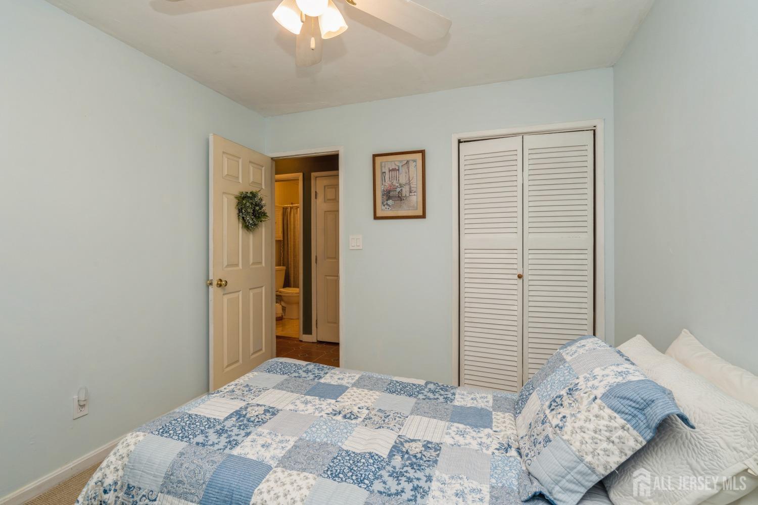 22 Constable Road Kendall Park, NJ 08824 - Photo 14 of 32 a bedroom with a bed and a chandelier
