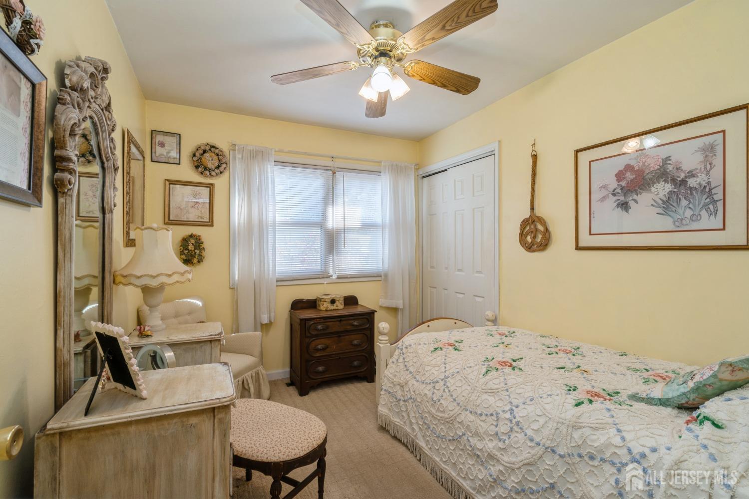 22 Constable Road Kendall Park, NJ 08824 - Photo 16 of 32 a bedroom with a bed a couch and a chandelier