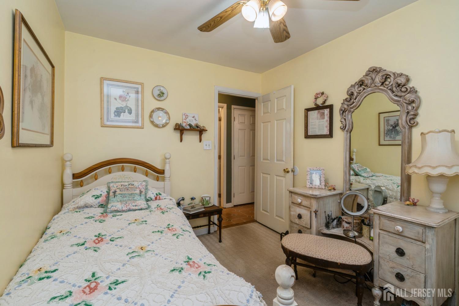 22 Constable Road Kendall Park, NJ 08824 - Photo 17 of 32 a bedroom with a bed a chandelier and a dresser