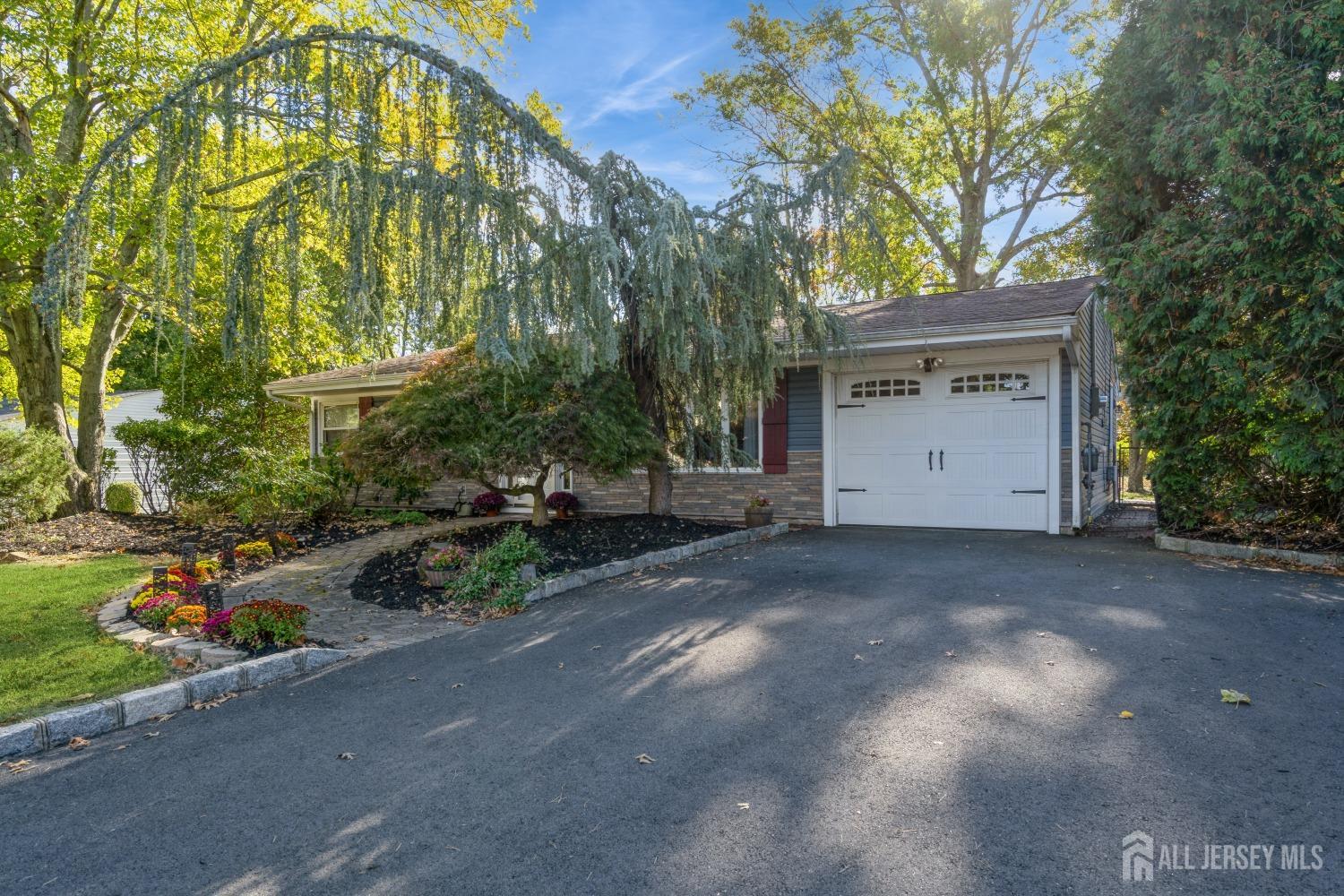 22 Constable Road Kendall Park, NJ 08824 - Photo 2 of 32 a view of a house with a yard and garage