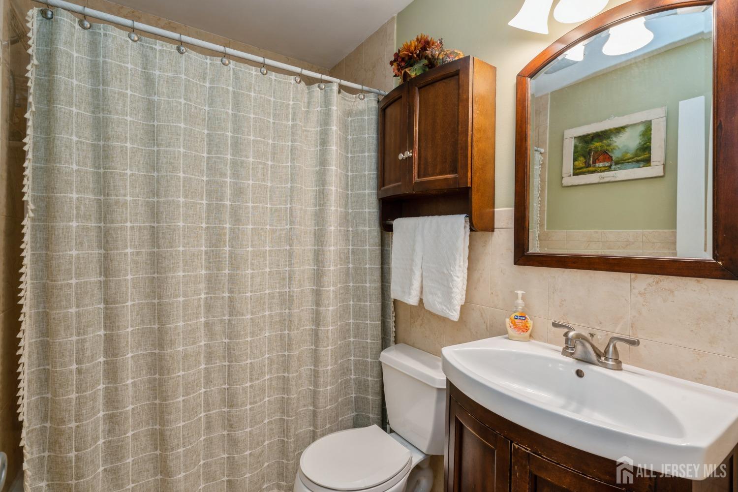 22 Constable Road Kendall Park, NJ 08824 - Photo 21 of 32 a bathroom with a sink toilet and mirror