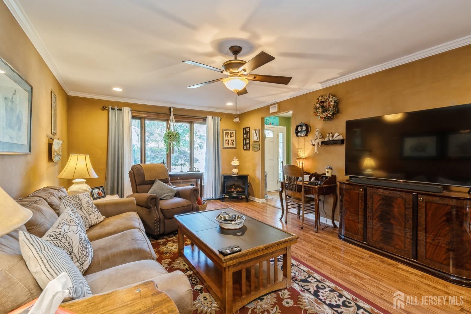 22 Constable Road Kendall Park, NJ 08824 - Photo 24 of 32 a living room with furniture and a flat screen tv