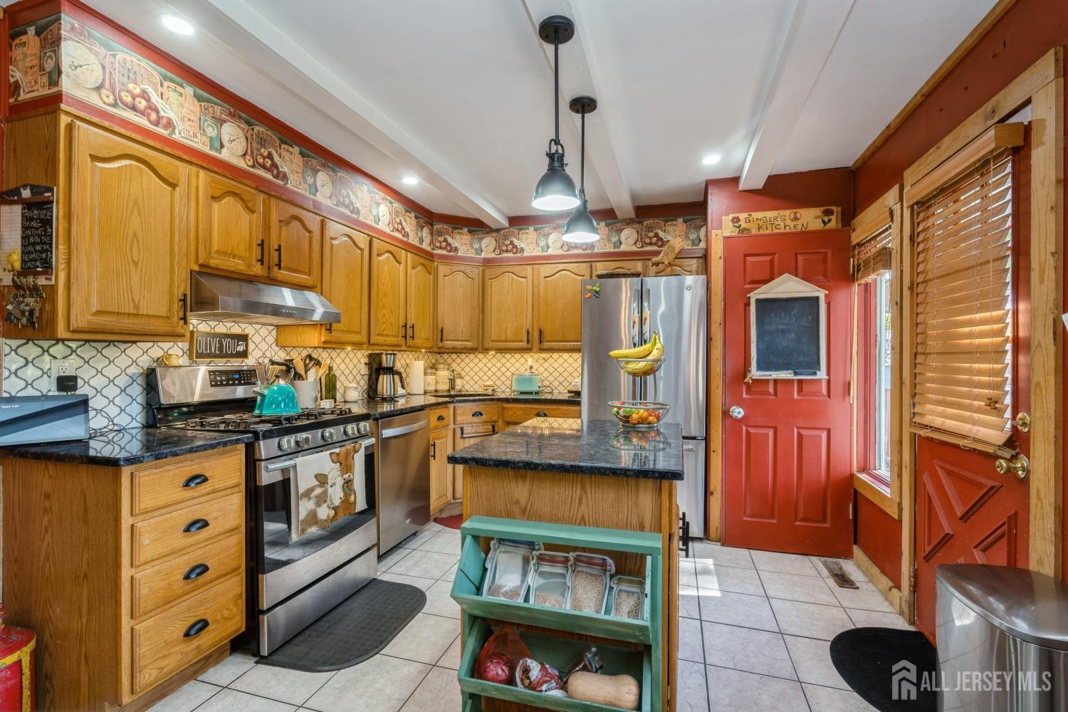 22 Constable Road Kendall Park, NJ 08824 - Photo 26 of 32 a kitchen with stainless steel appliances granite countertop a stove and cabinets