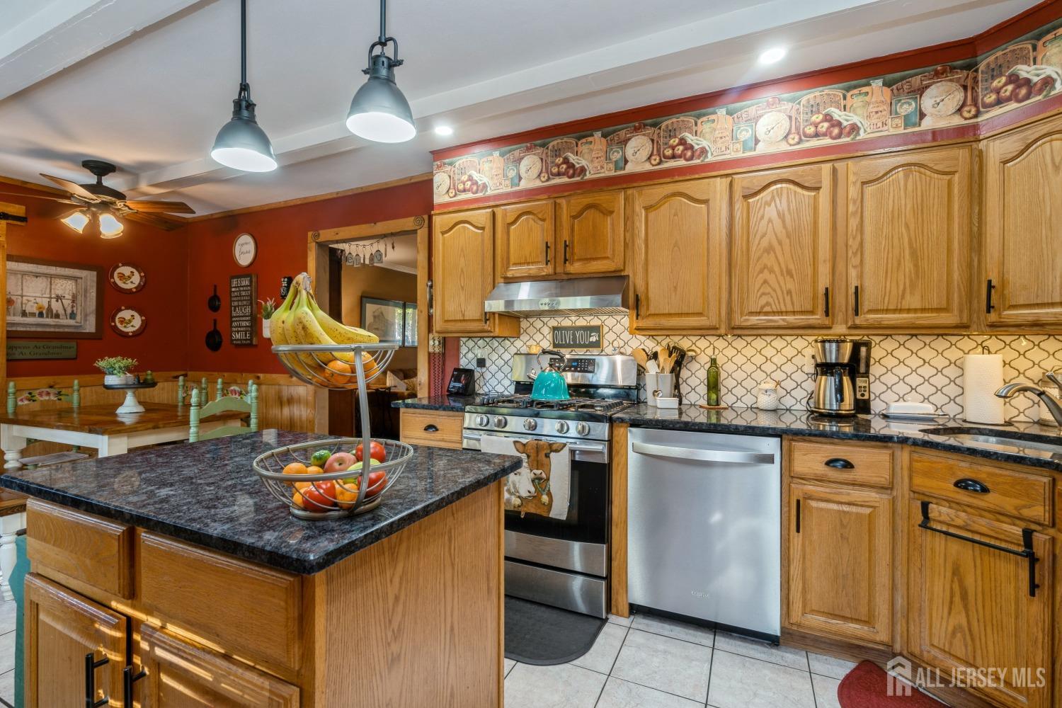 22 Constable Road Kendall Park, NJ 08824 - Photo 28 of 32 a kitchen with kitchen island granite countertop a sink appliances cabinets and a counter top space