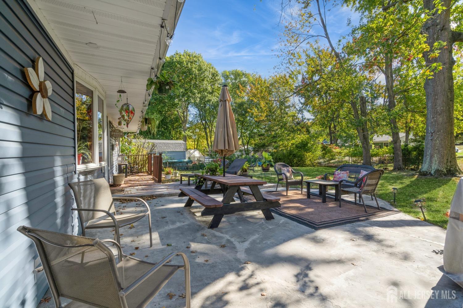 22 Constable Road Kendall Park, NJ 08824 - Photo 4 of 32 a view of a patio with table and chairs and a barbeque