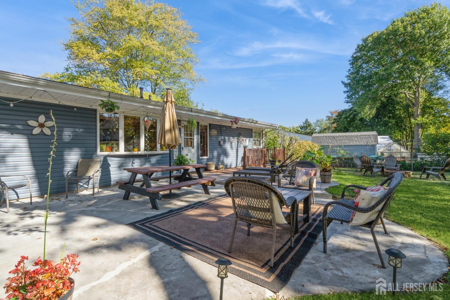 22 Constable Road Kendall Park, NJ 08824 - Photo 5 of 32 a view of a patio with table and chairs and potted plants