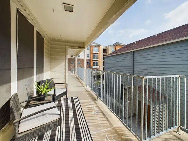 a view of balcony with furniture