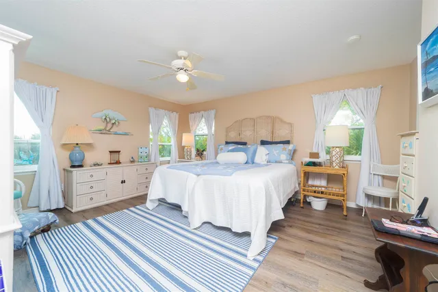 a bed room with bed and a large window