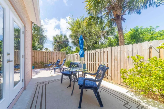 a view of a porch with chairs and backyard
