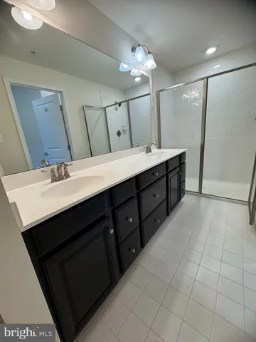 a bathroom with a double vanity sink a and a mirror