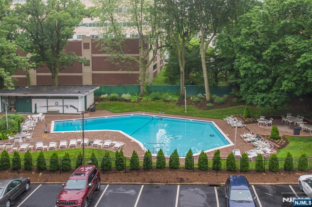 301 Beech Street, Unit 3DD Hackensack, NJ 07601 - Photo 12 of 16 a view of a patio with a table and chairs under an umbrella