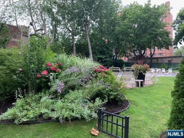 301 Beech Street, Unit 3DD Hackensack, NJ 07601 - Photo 16 of 16 a view of a garden with plants and large trees