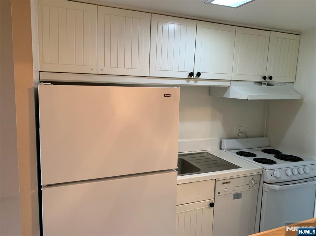301 Beech Street, Unit 3DD Hackensack, NJ 07601 - Photo 6 of 16 a kitchen with stainless steel appliances white cabinets and a sink