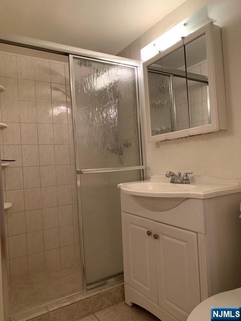 301 Beech Street, Unit 3DD Hackensack, NJ 07601 - Photo 7 of 16 a bathroom with a shower sink and mirror