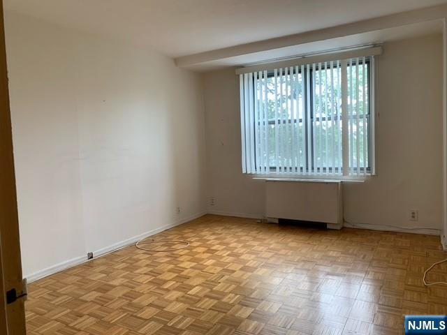 301 Beech Street, Unit 3DD Hackensack, NJ 07601 - Photo 10 of 16 an empty room with wooden floor and windows