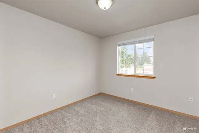 an empty room with closet area