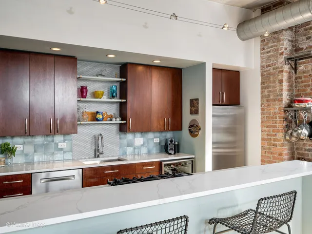 a kitchen with granite countertop a refrigerator and a sink